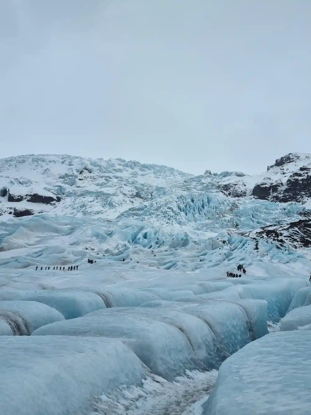 Blue ice tunnel opening in glacier interior