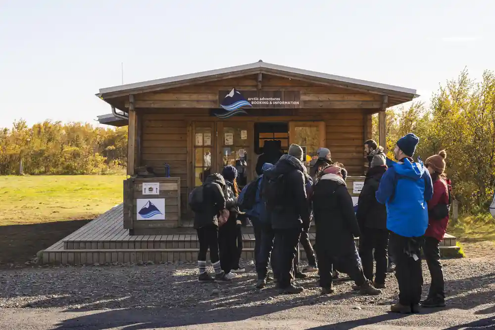 Group standing at visitor centre wooden building