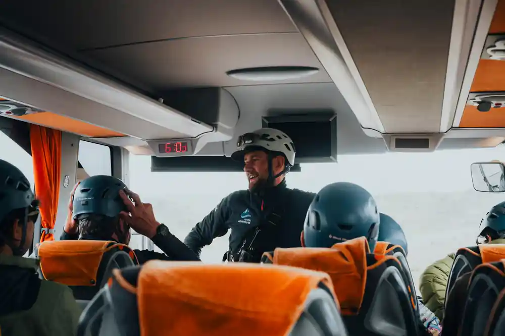 Guide briefing passengers inside tour coach interior