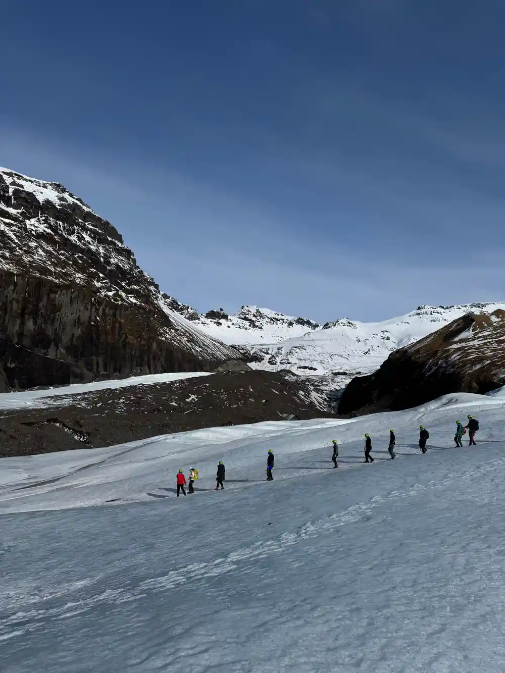 Large dark hole or tunnel in white glacier ice face