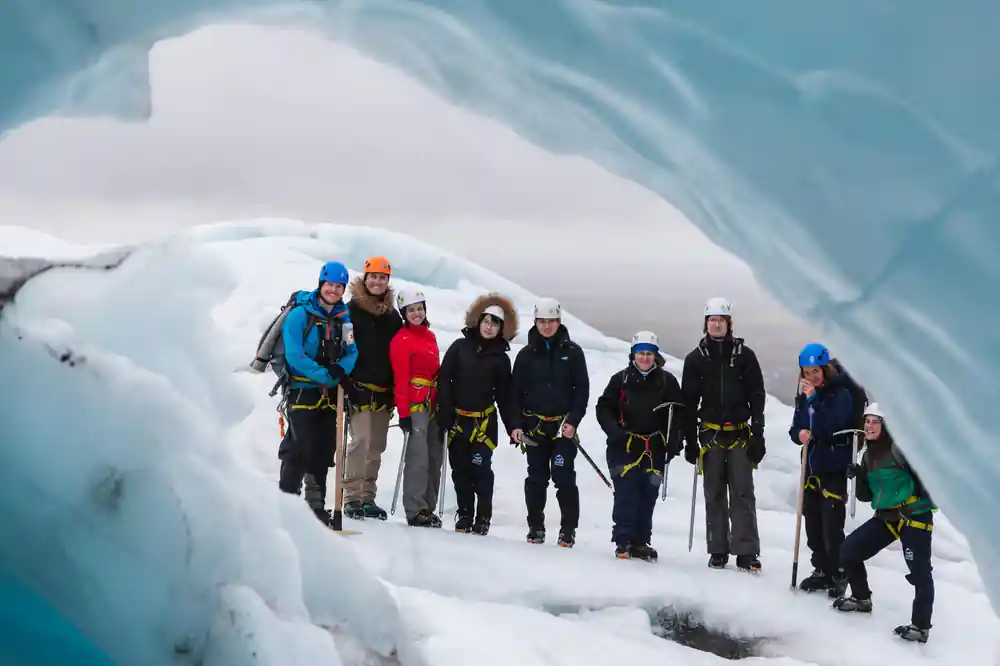 Large group standing in ice cave opening
