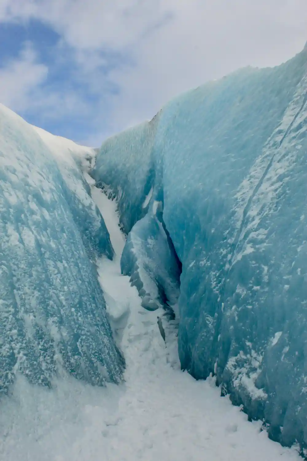 Narrow ice gorge between tall blue-white walls