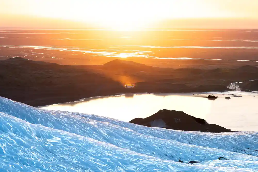 Sunrise over frozen landscape with glaciers and water