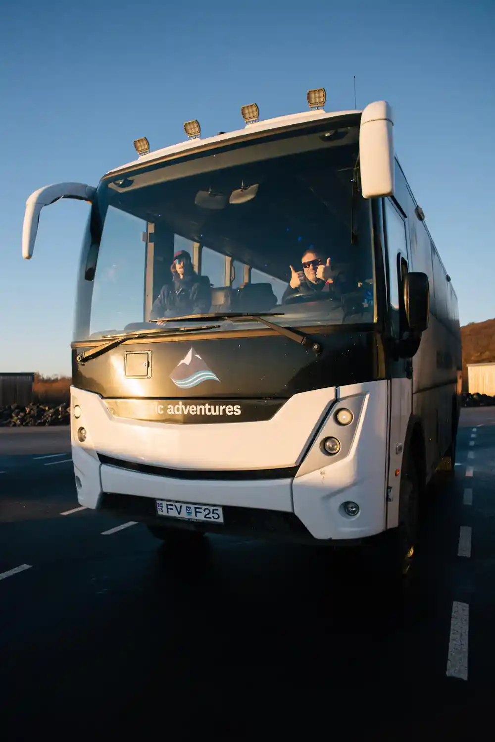 White and grey tour coach parked at daytime